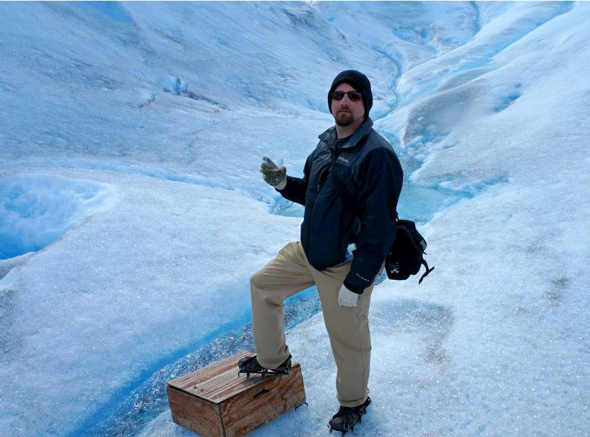 Wesley Holland posing atop a glacier.